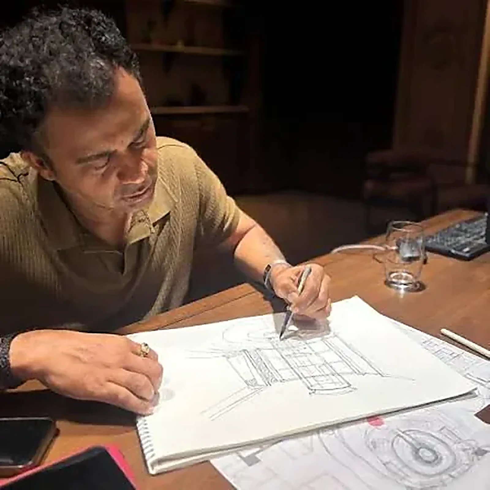 Engineer drafting architectural shop drawings at a desk