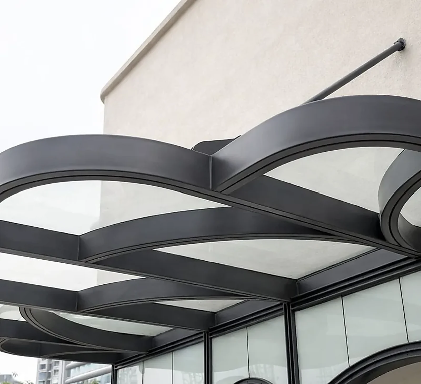 Black architectural canopy above a glass facade