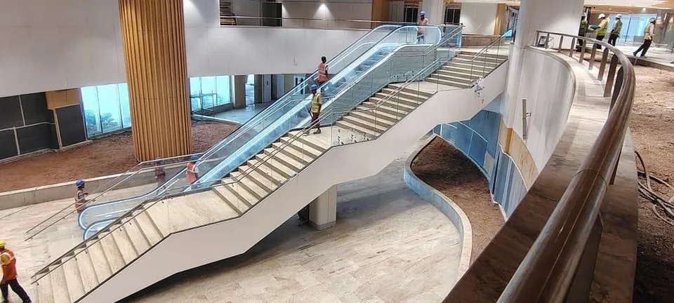 Escalator and staircase with glass balustrade at Navi Mumbai Airport